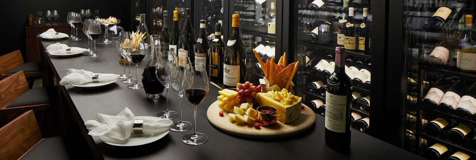 Wine vault with table set with red wine and cheese board