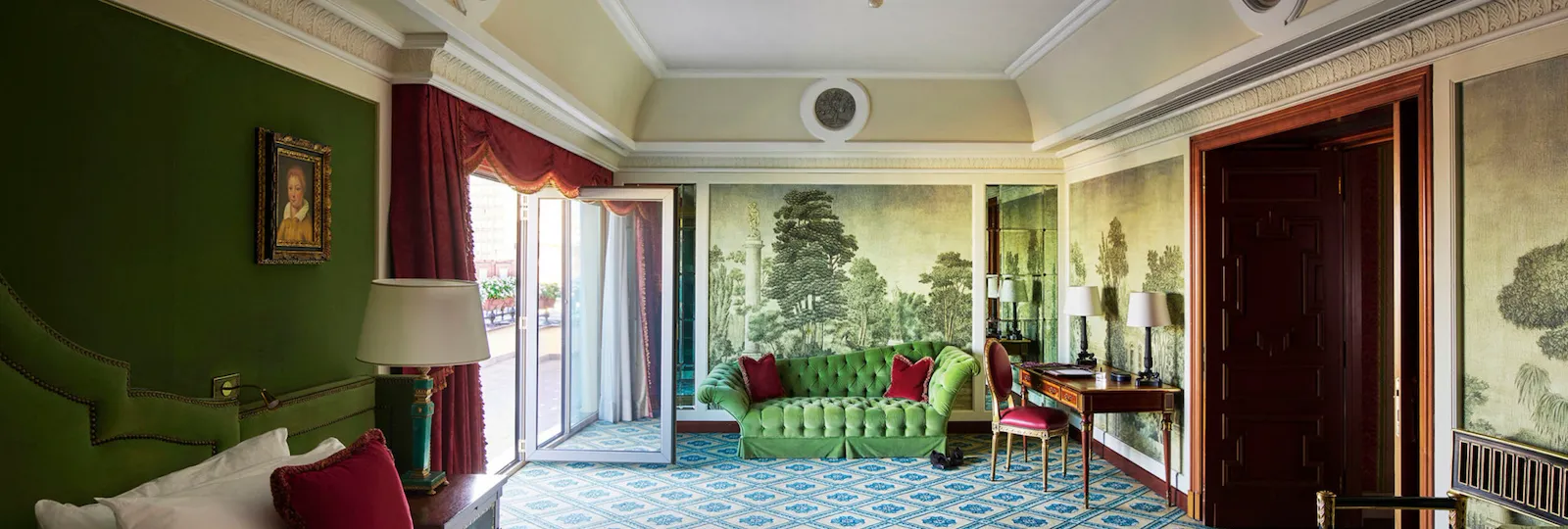 A large view of the second bedroom in the Presidential Suite with a focus on the wall hand-made painting and the terrace detail