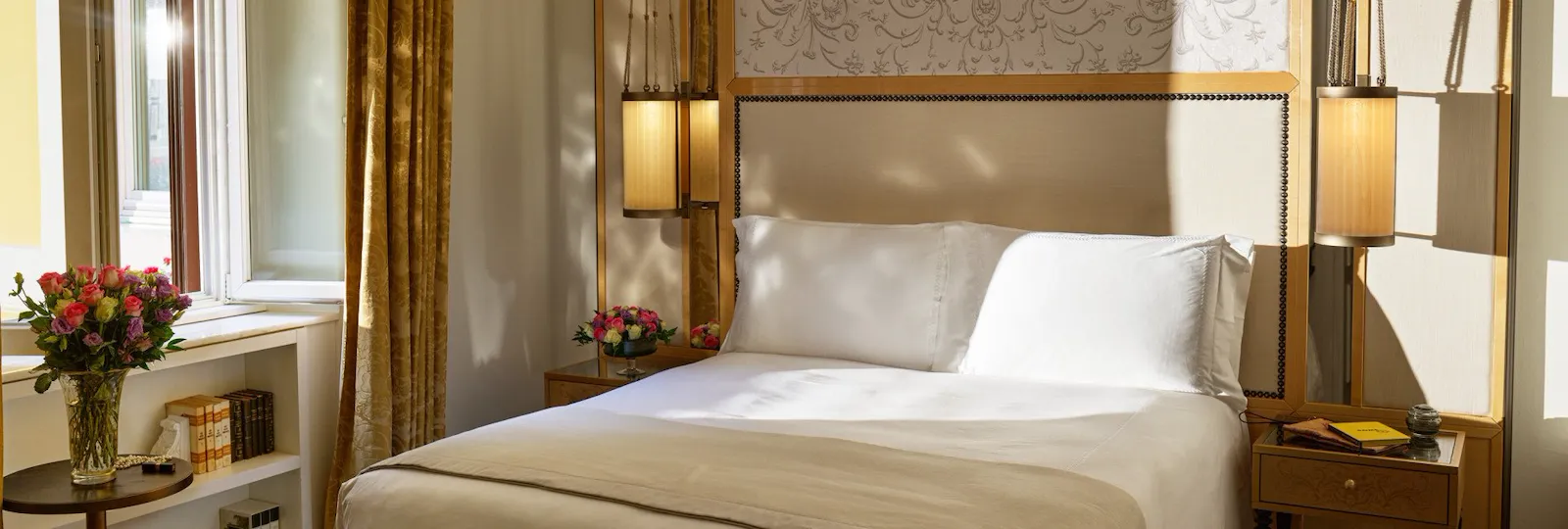 Bedroom of classic room with twin beds, headboard with peacocks illustration and window, at Hotel Eden, Rome