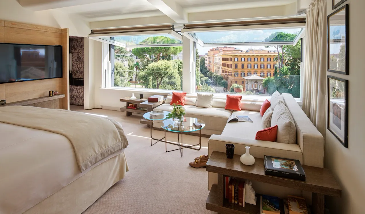 Bellavista Penthouse Suite bedroom with windows open to view of Rome, Hotel Eden