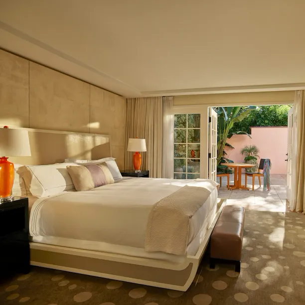 Patio Suite bedroom with open patio doors at Hotel Bel-Air, Los Angeles