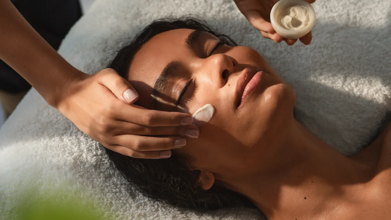 The Dorchester Spa Treatment Facial Cream being applied to woman's face