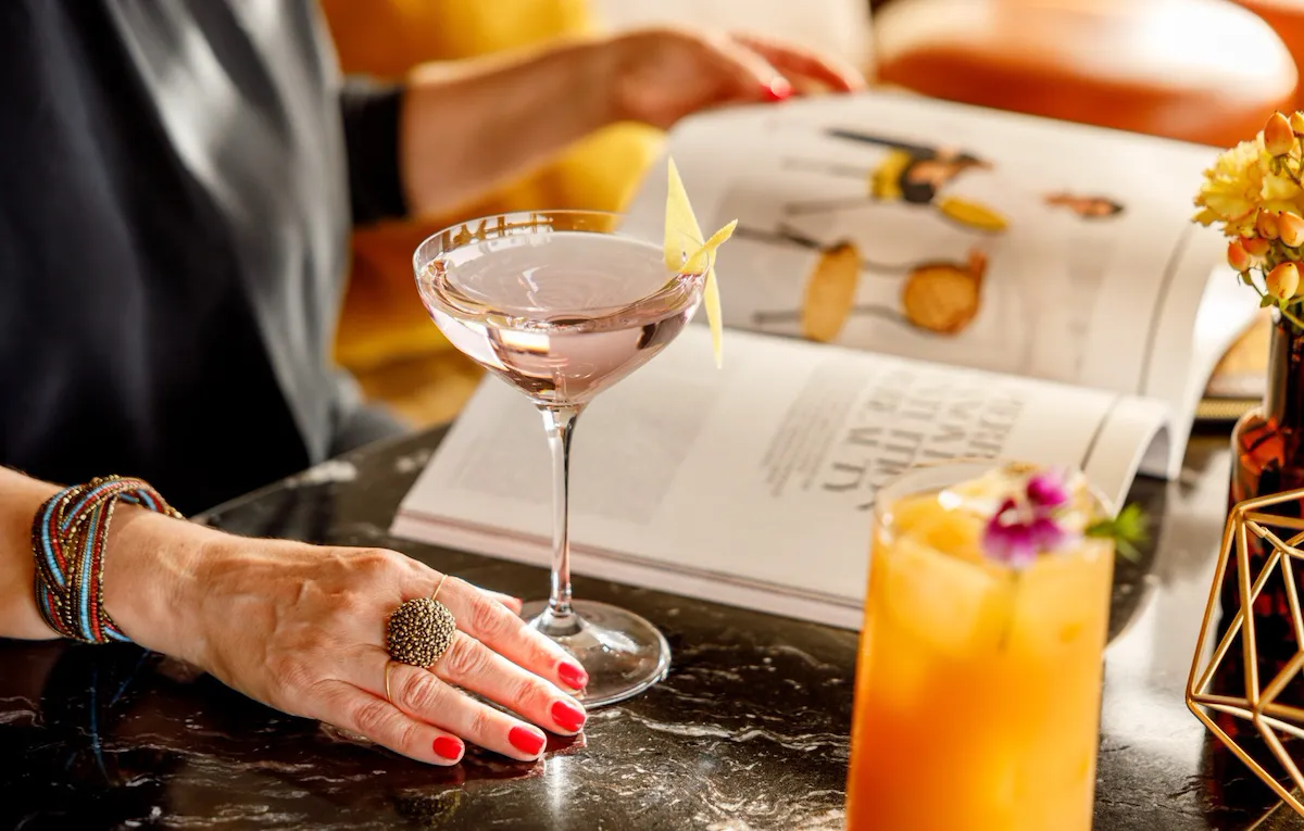 Lady with a drink reading a magazine at Il Giardino Ristorante