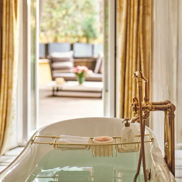 Bathtub filled with water in Aurora Terrace Suite at Hotel Eden rome