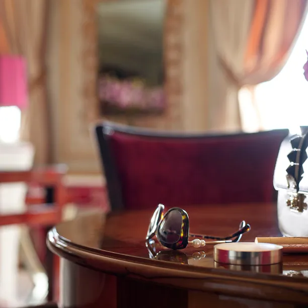 Imperial Executive Suite Detail with sunglasses, make up essentials and a pale brown handbag