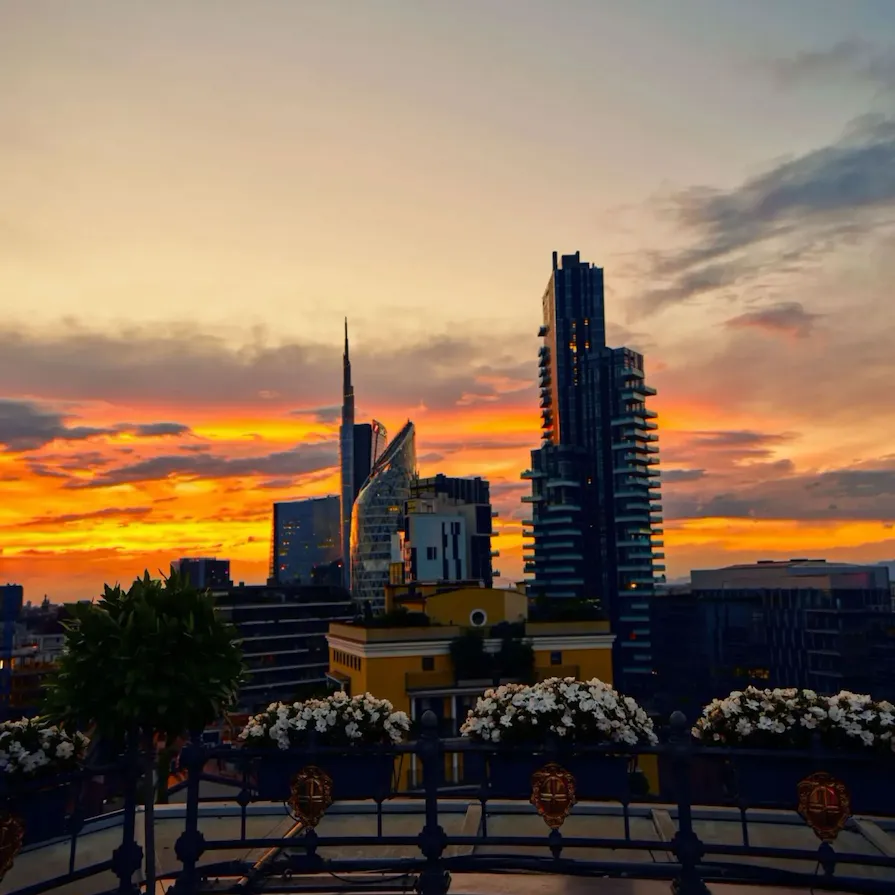 view from Hotel Principe di Savoia rooftop on Porta Nuova district with sunset