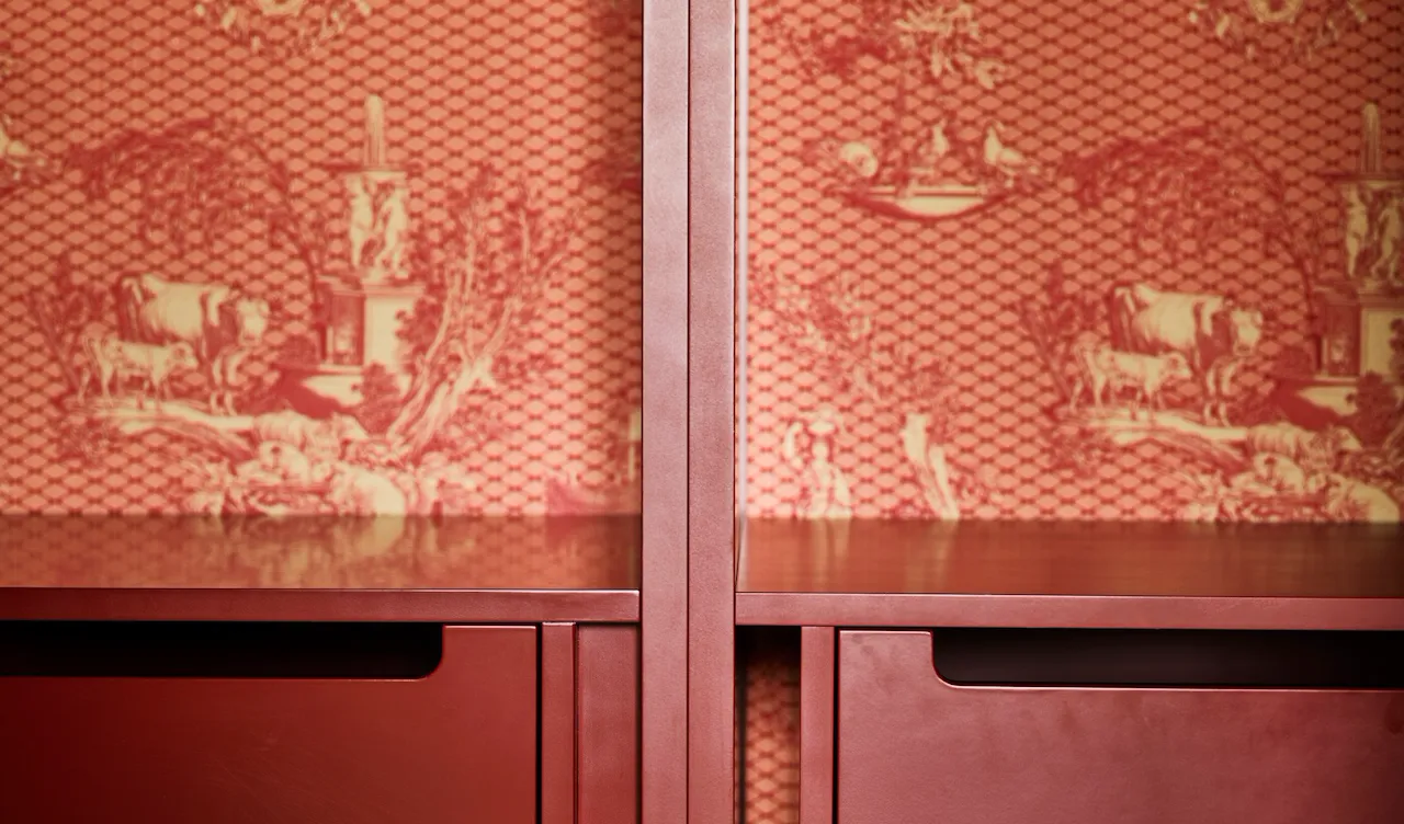 Detail of wardrobe with red drawers and wallpaper at Prestige Suite at Hotel Eden, Rome
