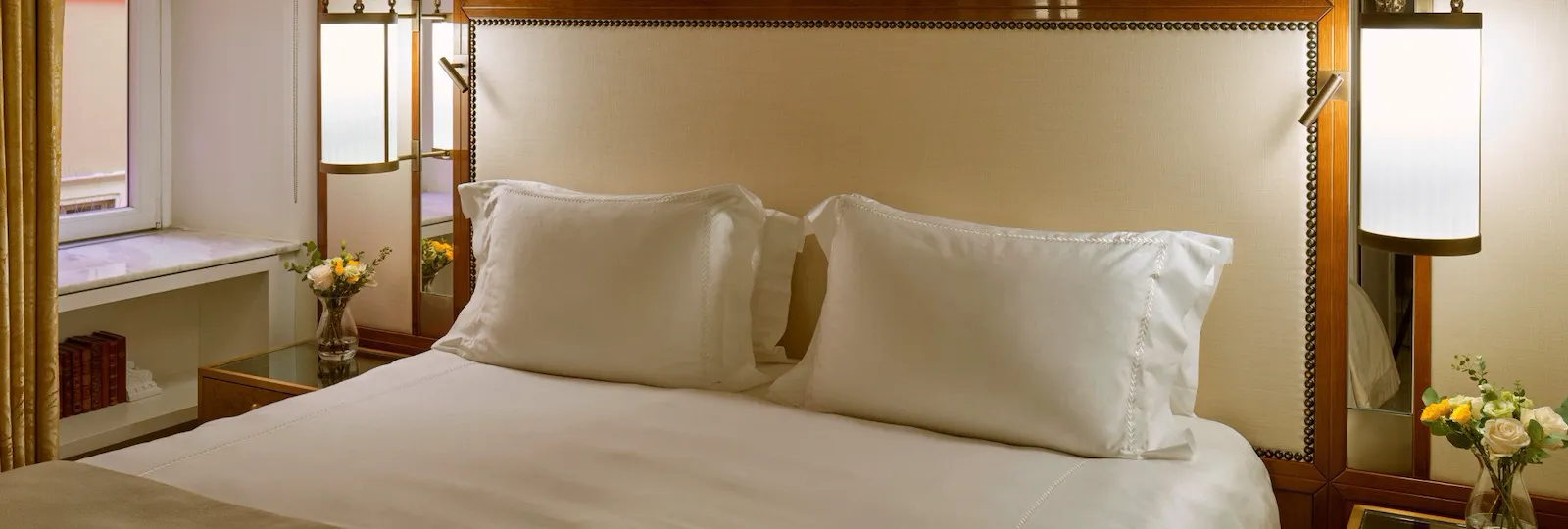 Bedroom of Classic suite and headboard with peacocks decoration at Hotel Eden, Rome