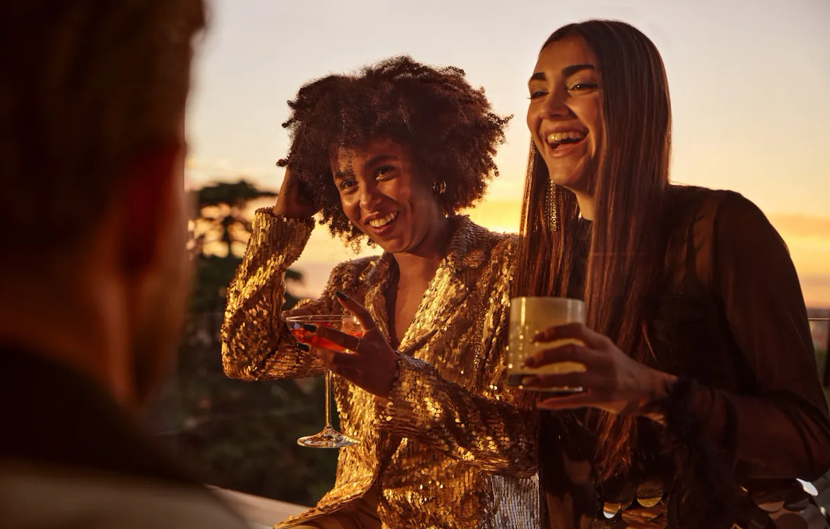 Portrait of smiling ladies having a drink at sunset, Il Giardino Bar, Hotel Eden