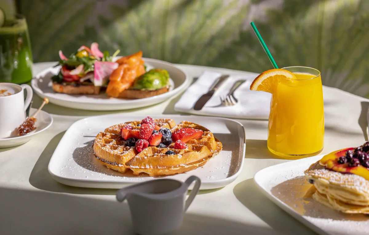Breakfast spread featuring waffles in Polo Lounge at The Beverly Hills Hotel
