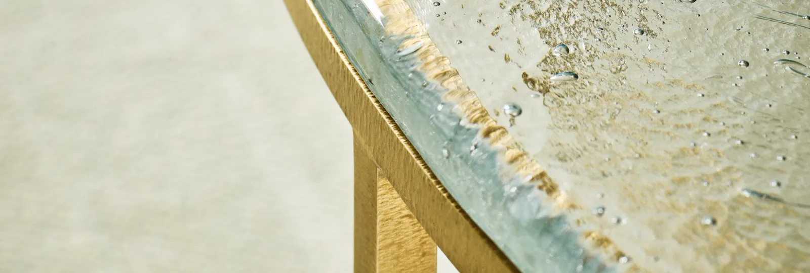 Detail of small table with glass tabletop inside Junior Suite at Hotel Eden, Rome