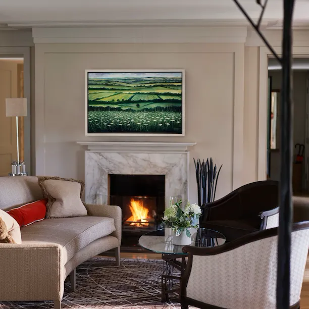 Gardener's East Cottage Suite living area with fireplace at Coworth Park, Ascot