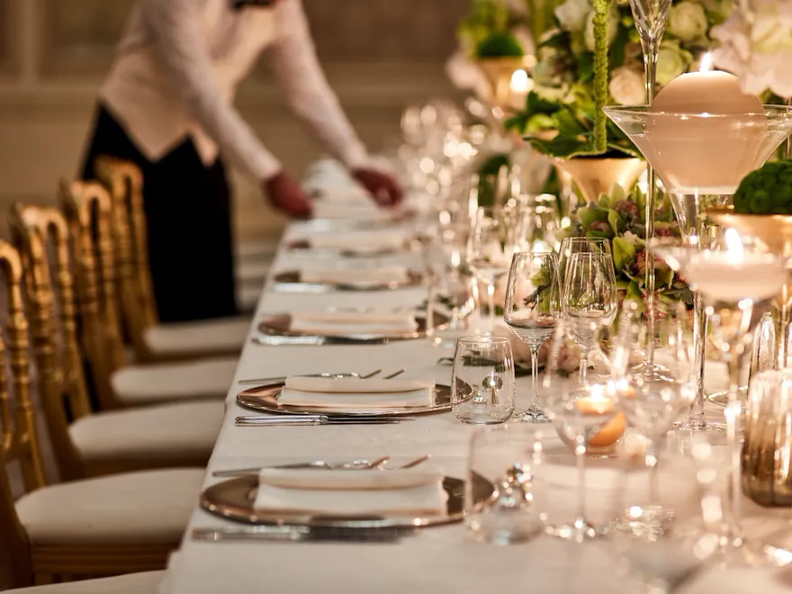 Cristalli Gala Room table set up for event with waiter arranging table at Hotel Principe Di Savoia, Milan
