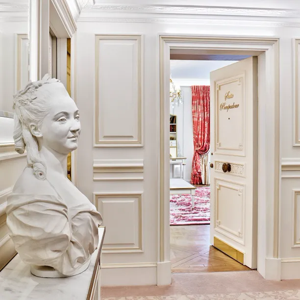 Entrance of the Pompadour suite with a statue at Le Meurice, Paris.