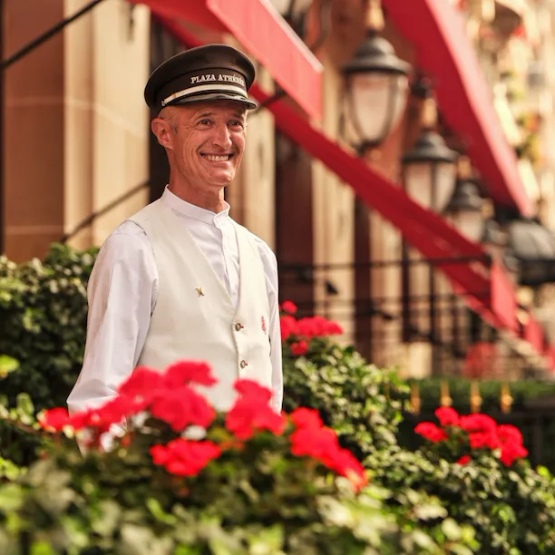 This is a close-up shot of the doorman in front of the entrance of the Plaza Athénée.