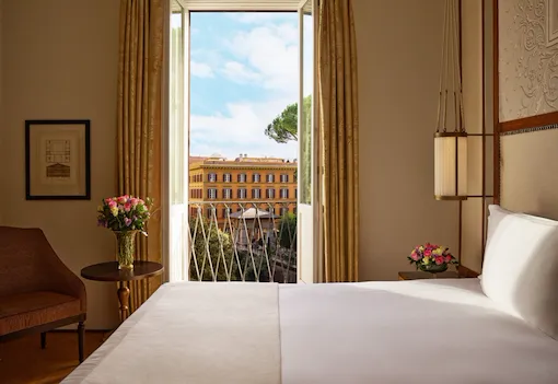 Bedroom of classic room with view, with open window looking at via Ludovisi, Hotel Eden, Rome