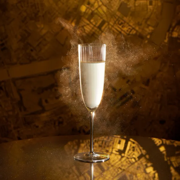 Signature cocktail at Artists' Bar presented in front of its artwork