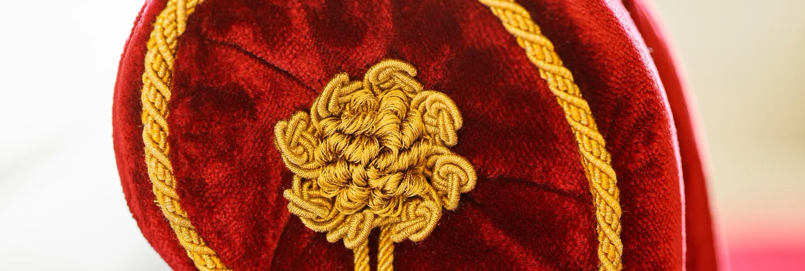 Red couch with golden details at Dolce Vita Suite at Hotel Eden, Rome