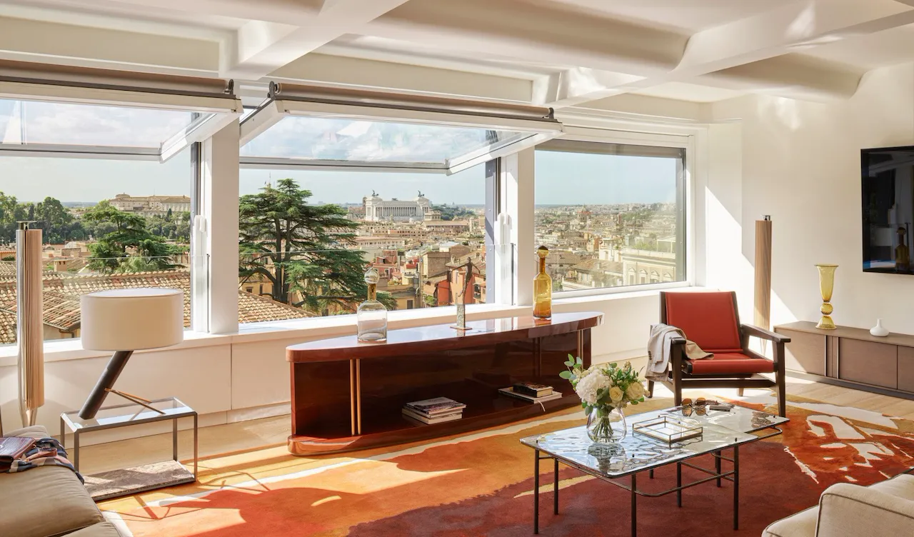 Bellavista Penthouse Suite living room with windows open and view at Hotel Eden, Rome