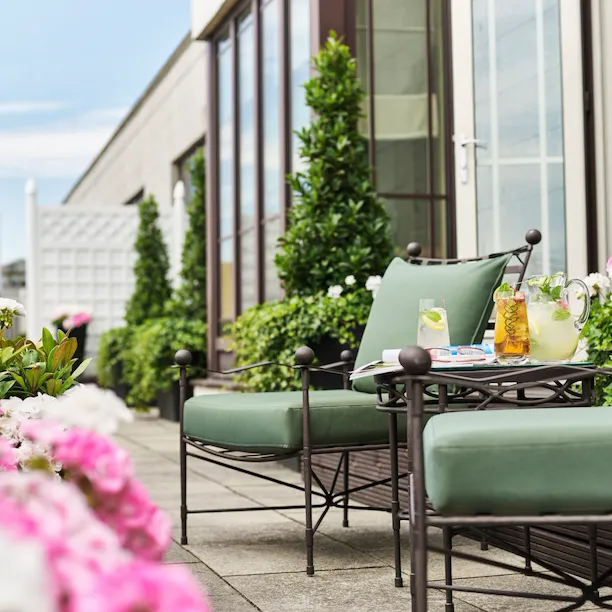 The Dorchester Harlequin Penthouse terrace with seating area and flowers
