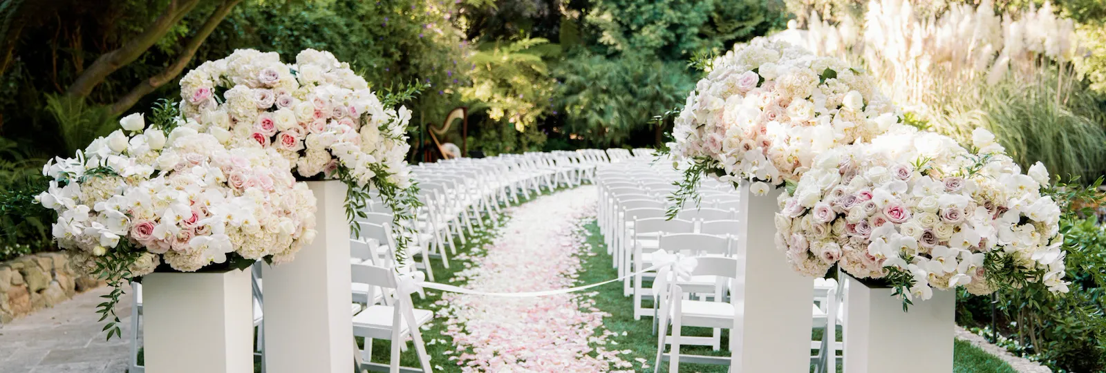 Wedding ceremony set up outside with pink roses at Hotel Bel-Air, Los Angeles