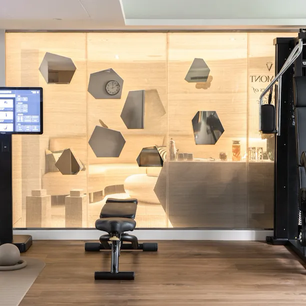 Modern gym with equipment and a glass wall, ready for workout in a bright setting