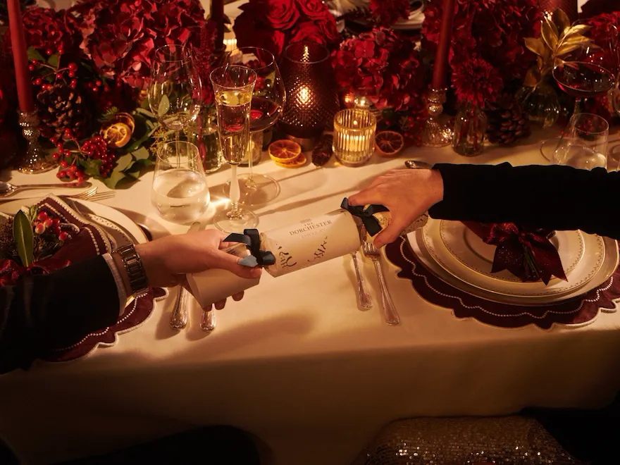 Festive Events at The Dorchester - Two guests pulling a Dorchester Christmas cracker